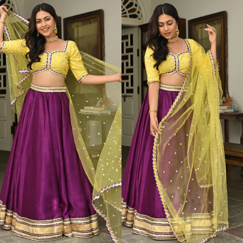 A vibrant yellow and purple lehenga set with intricate embroidery.